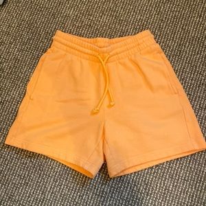 TNA Orange aritzia 5” sweatshorts.